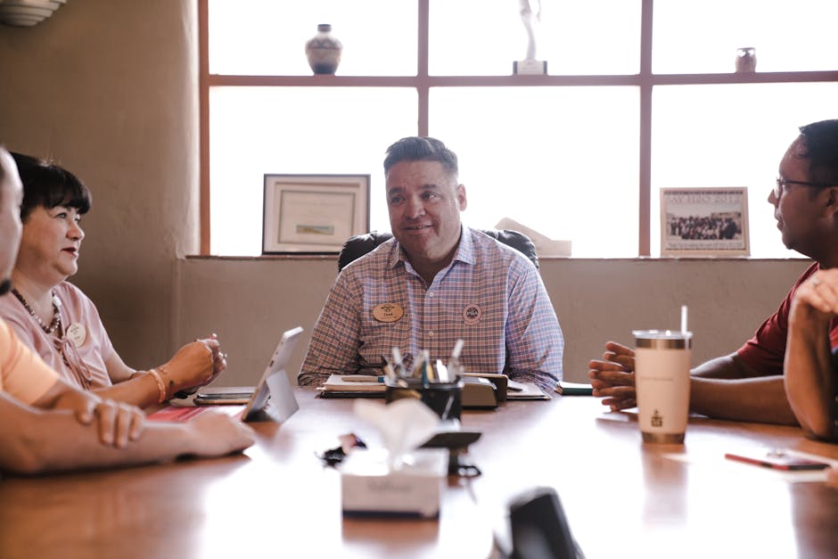 Team engaged in a productive meeting at the office, discussing plans and ideas.